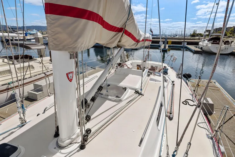 Slide: The Image of 1994 J Boats J/130 sailboat docked at marina, showcasing deck and rigging. - 14