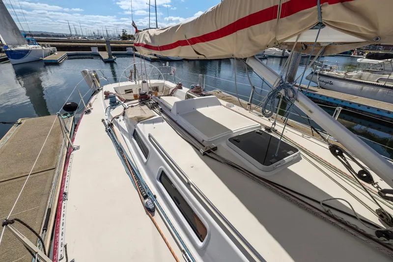 Slide: The Image of Sailboat J/130 from 1994 docked at marina, showcasing deck and rigging. - 16