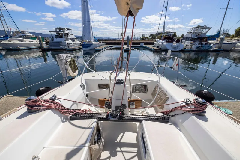 Slide: The Image of Cockpit view of a 1994 J Boats J/130 sailboat docked in a marina. - 19