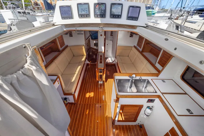Slide: The Image of Interior of 1994 J Boats J/130 sailboat with wood flooring and navigation instruments. - 22