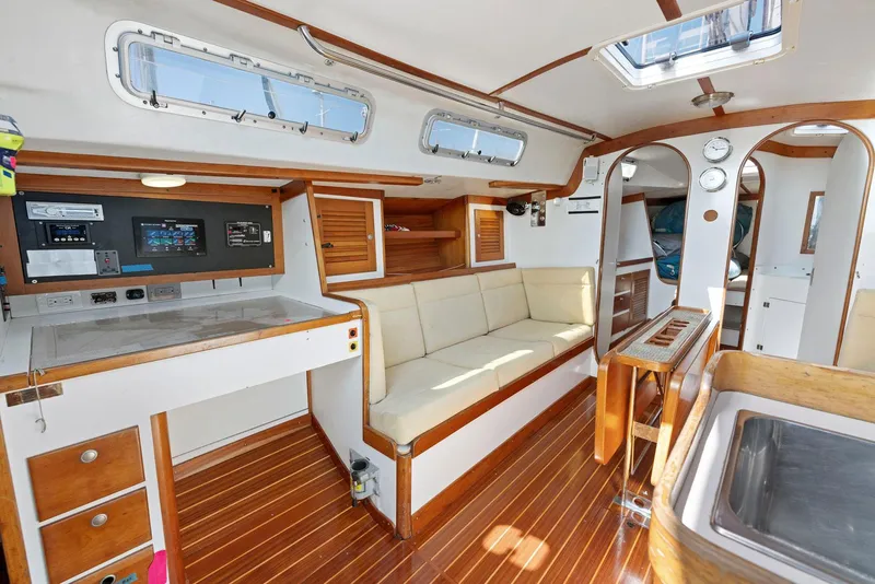 Slide: The Image of Interior of 1994 J Boats J/130 sailboat with wood accents and navigation station. - 23