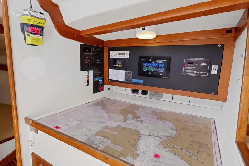 Slide: The Image of Navigation station on a 1994 J Boats J/130, featuring charts and electronic equipment. - 24