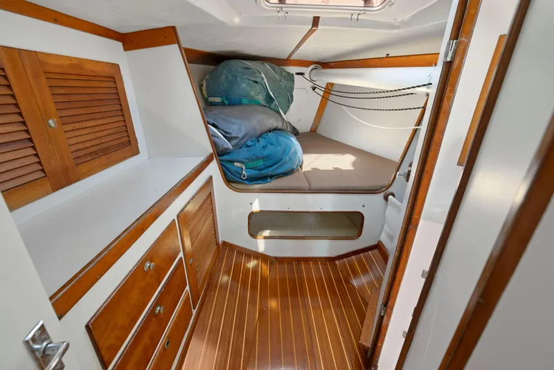 Slide: The Image of 1994 J Boats J/130 cabin interior with wood finish and storage compartments. - 32