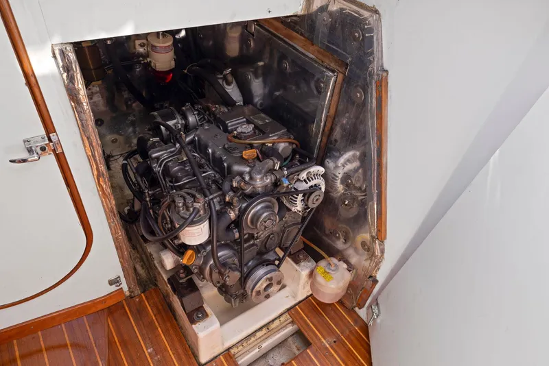Slide: The Image of Engine compartment of a 1994 J Boats J/130 sailboat, showcasing the engine and surrounding area. - 35