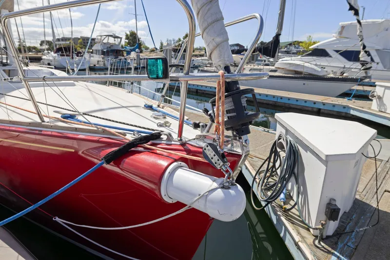 Slide: The Image of Red 1994 J Boats J/130 sailboat docked at marina with clear skies. - 4