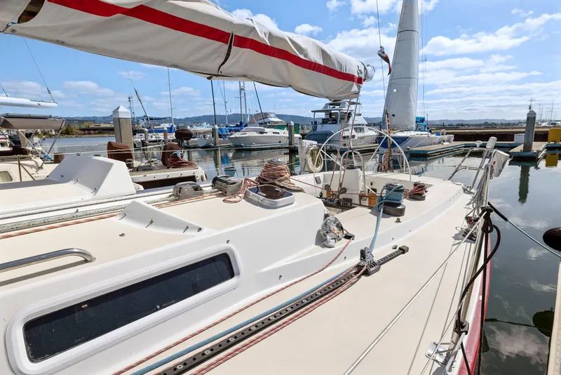 Slide: The Image of Sailboat J/130 from 1994 docked in a marina under a clear blue sky. - 9