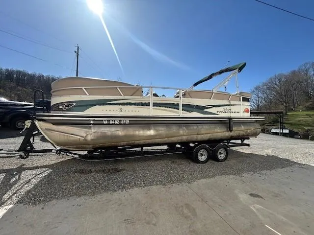 Slide: The Image of 2010 Sun Tracker PARTY BARGE 22 Regency Edition pontoon boat on trailer, parked outdoors. - 25