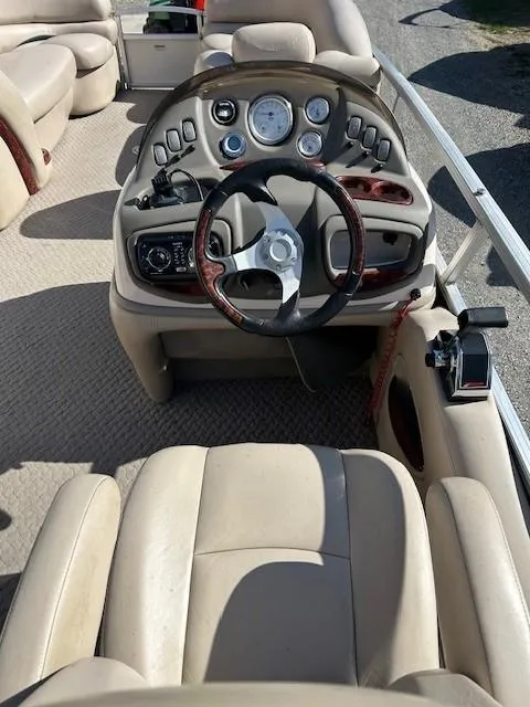 Slide: The Image of 2010 Sun Tracker PARTY BARGE 22 Regency Edition boat interior with steering console and seating. - 30