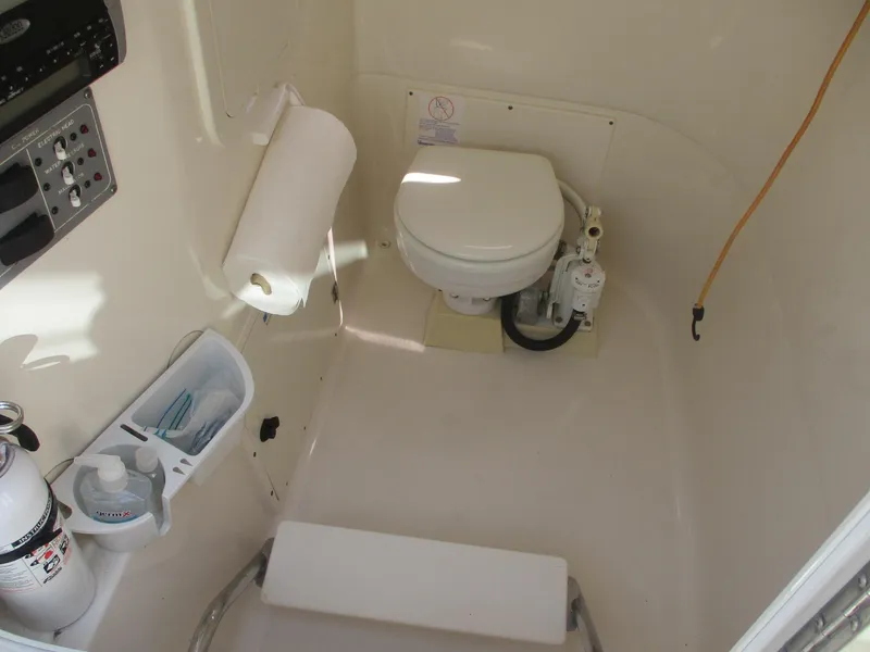 Slide: The Image of 2006 Pursuit 2670 Center Console boat interior with toilet and amenities. - 21