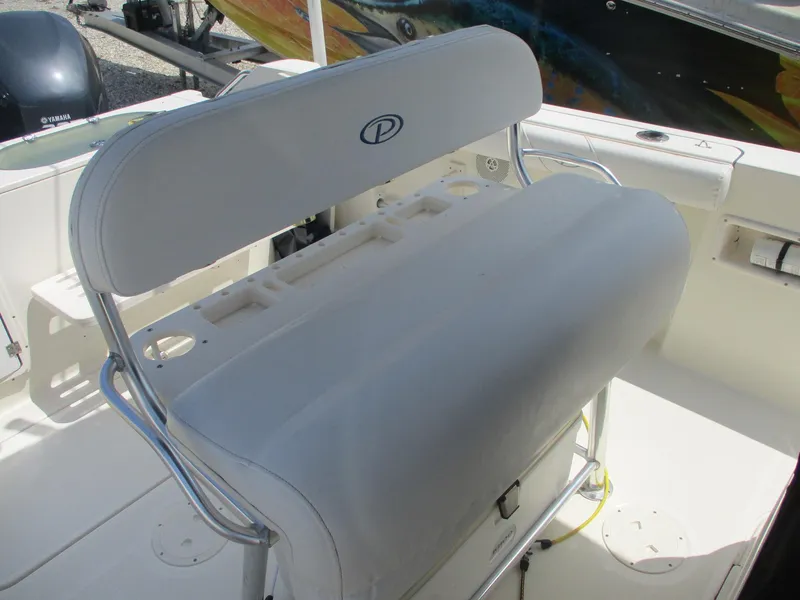 Slide: The Image of 2006 Pursuit 2670 Center Console boat seat with white cushioned backrest and metal frame. - 23