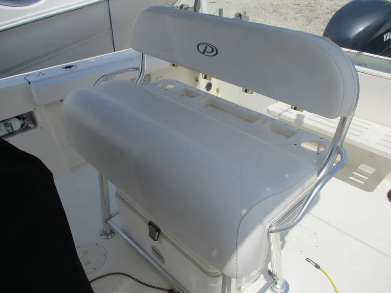Slide: The Image of 2006 Pursuit 2670 Center Console boat seat with storage and rod holders. - 24