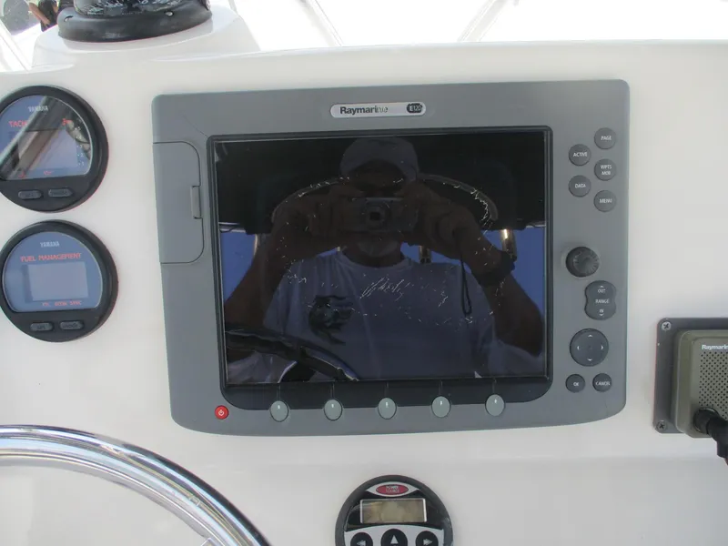 Slide: The Image of 2006 Pursuit 2670 Center Console dashboard with Raymarine display and gauges. - 26
