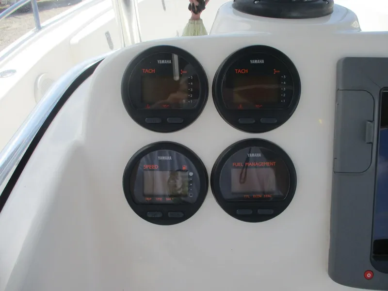 Slide: The Image of Dashboard of a 2006 Pursuit 2670 Center Console boat with Yamaha gauges. - 27