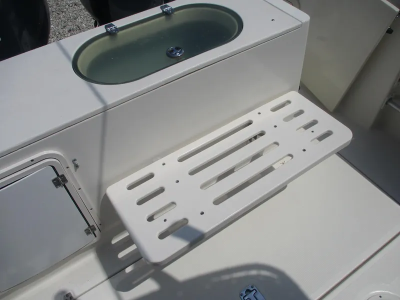 Slide: The Image of 2006 Pursuit 2670 Center Console boat interior with livewell and storage compartment. - 7