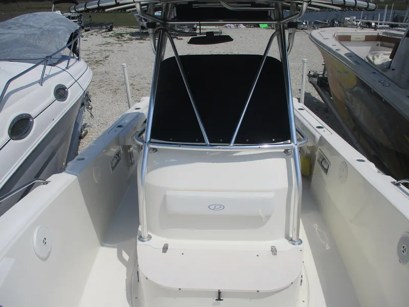 Slide: The Image of 2006 Pursuit 2670 Center Console boat, white interior, docked among other boats. - 9