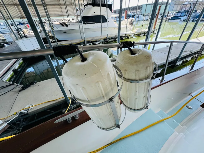Slide: The Image of Two white fenders on a 1984 Fu Hwa Sea Horse 34 boat in a marina. - 11