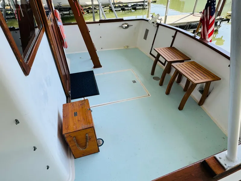Slide: The Image of 1984 Fu Hwa Sea Horse 34 boat deck with wooden furniture and American flag. - 14
