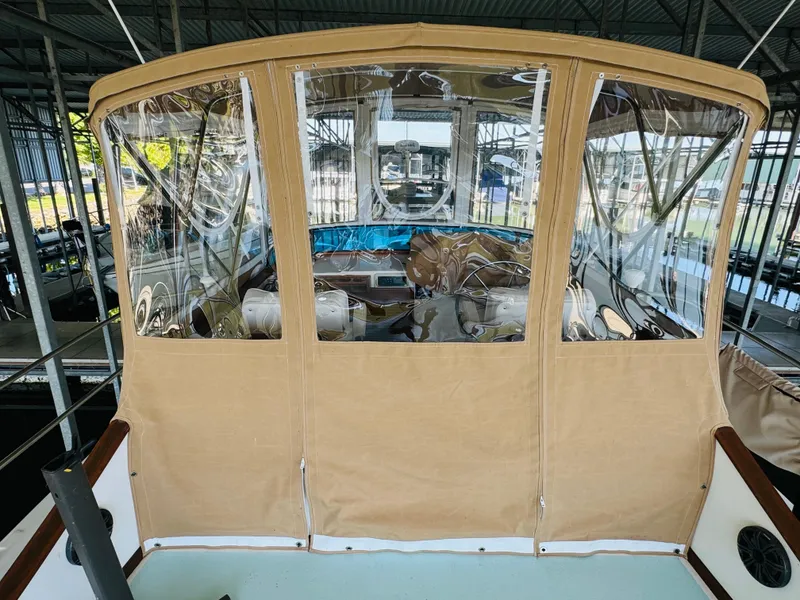 Slide: The Image of 1984 Fu Hwa Sea Horse 34 boat with tan canvas enclosure in a marina. - 18