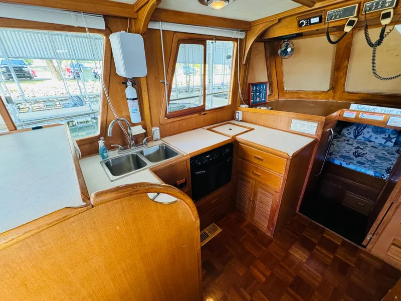 Slide: The Image of 1984 Fu Hwa Sea Horse 34 boat interior with wooden cabinetry and kitchen area. - 27