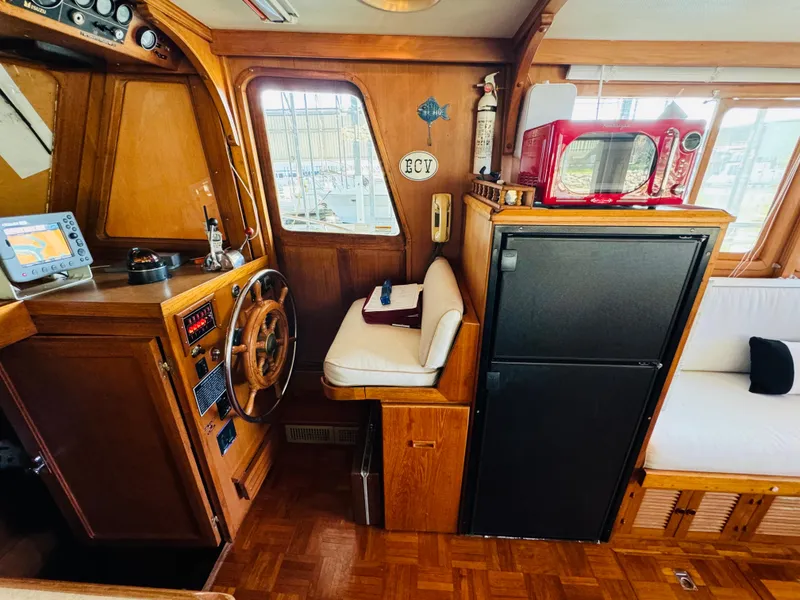 Slide: The Image of 1984 Fu Hwa Sea Horse 34 boat interior with helm, seating, and kitchen appliances. - 30