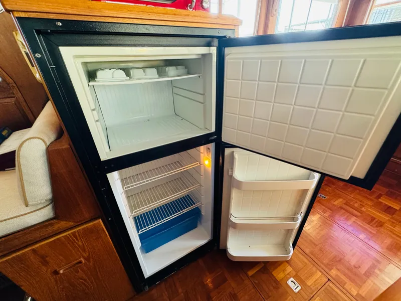 Slide: The Image of Open refrigerator on Fu Hwa Sea Horse 34 boat, 1984 model, showing interior shelves. - 36