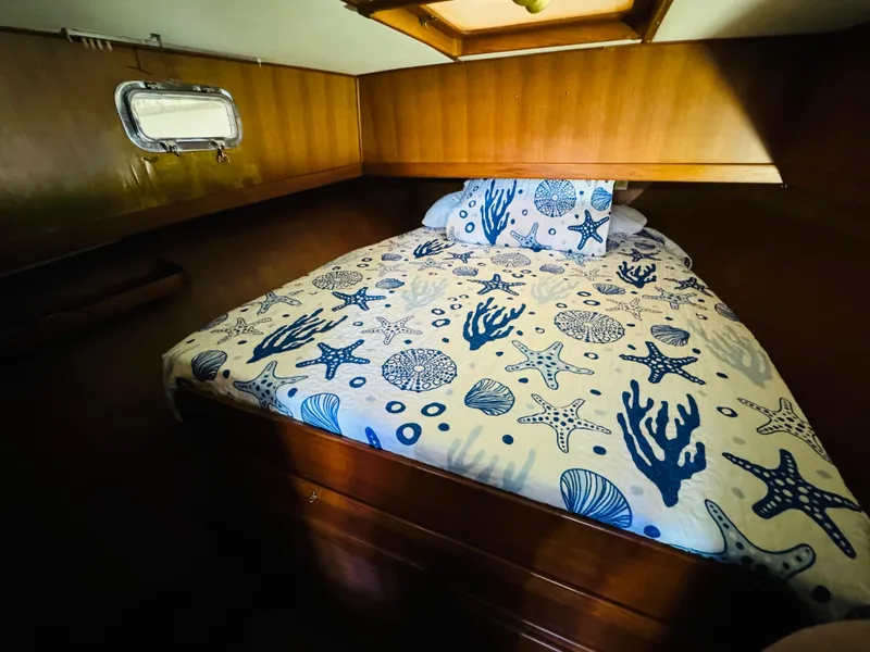 Slide: The Image of Cozy cabin bedroom in 1984 Fu Hwa Sea Horse 34 boat with nautical-themed bedding. - 38