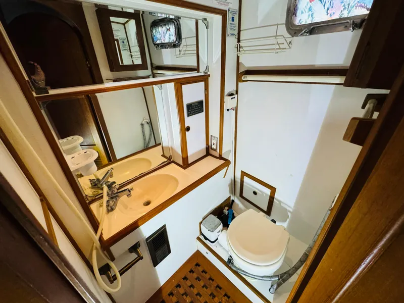 Slide: The Image of Compact bathroom in 1984 Fu Hwa Sea Horse 34 yacht, featuring sink, toilet, and wooden accents. - 39