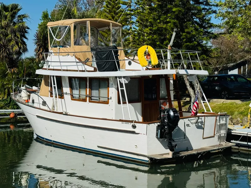 Slide: The Image of 1984 Fu Hwa Sea Horse 34 boat docked in a serene marina setting. - 5
