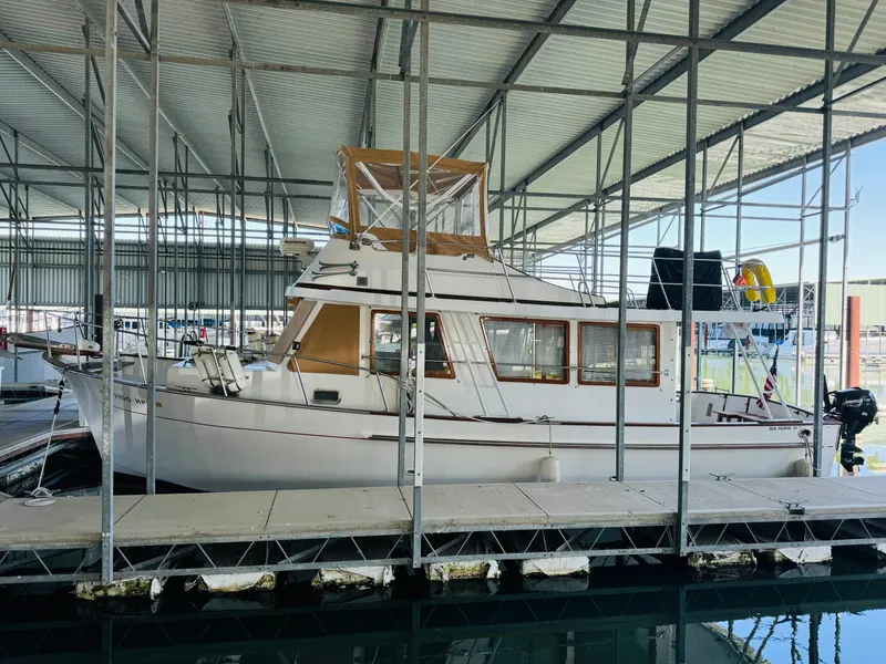 Slide: The Image of 1984 Fu Hwa Sea Horse 34 boat docked in a covered marina. - 7