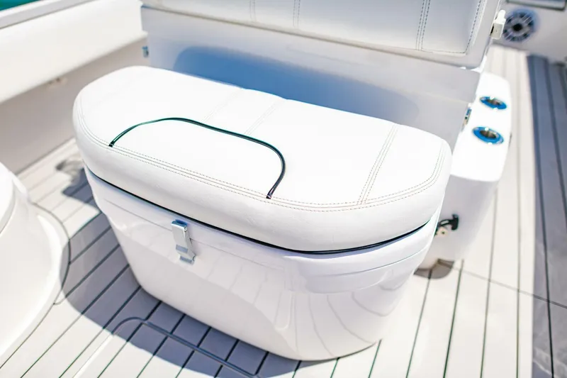 Slide: The Image of 2023 Contender 25 Bay boat seat with white cushioned storage on deck. - 15