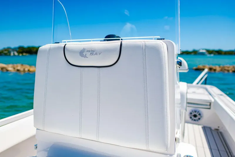 Slide: The Image of 2023 Contender 25 Bay boat seat with logo, set against a scenic water backdrop. - 16
