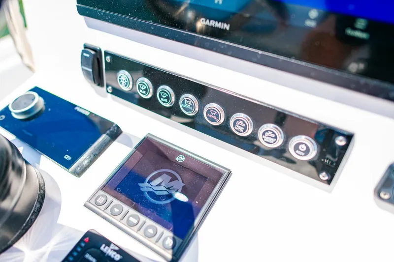 Slide: The Image of Control panel of 2023 Contender 25 Bay boat with Garmin display and buttons. - 22