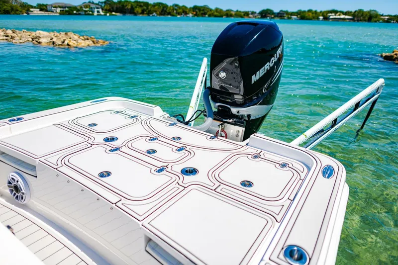 Slide: The Image of 2023 Contender 25 Bay boat with Mercury engine on clear blue water. - 23