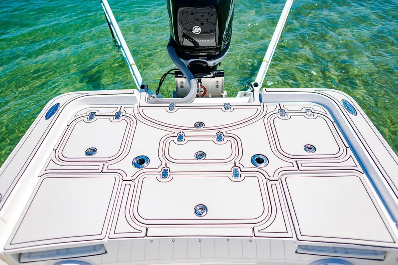 Slide: The Image of 2023 Contender 25 Bay boat deck with intricate design, set against clear blue water. - 26
