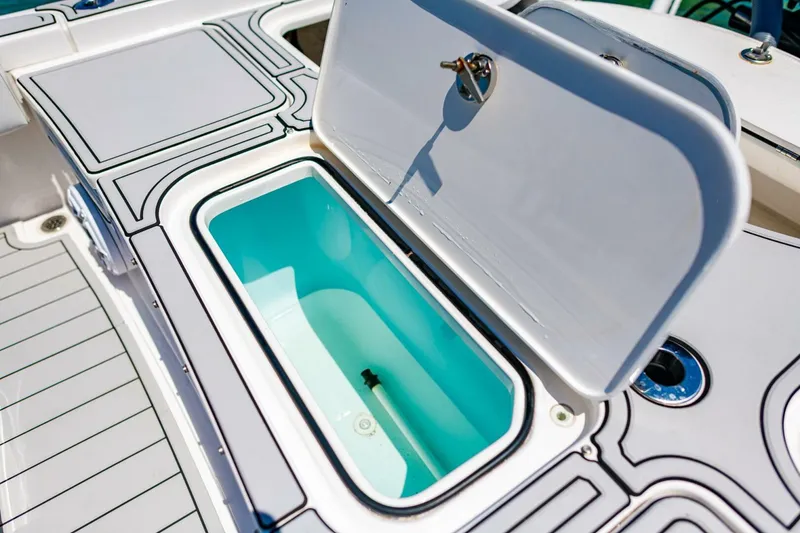 Slide: The Image of 2023 Contender 25 Bay boat with open storage compartment on deck. - 28