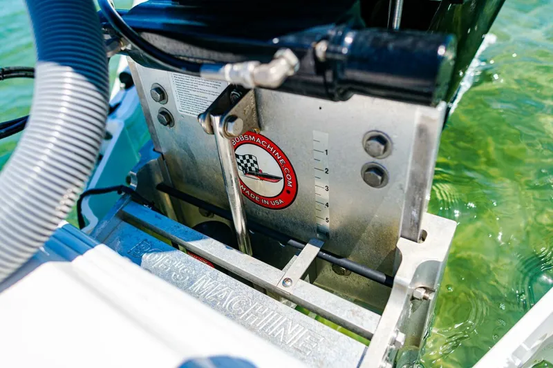 Slide: The Image of 2023 Contender 25 Bay boat engine mount in clear water, showcasing mechanical details. - 29