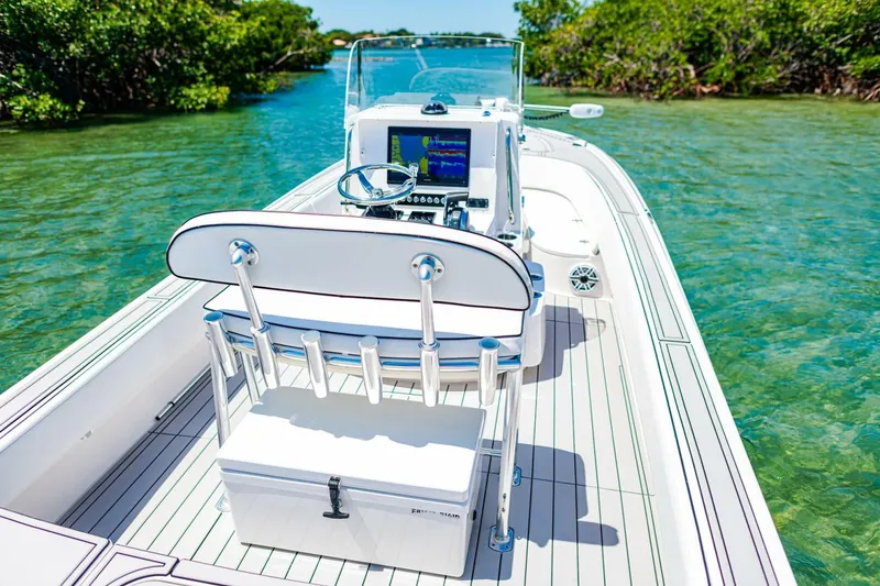 Slide: The Image of 2023 Contender 25 Bay boat on clear water, featuring sleek design and modern controls. - 30