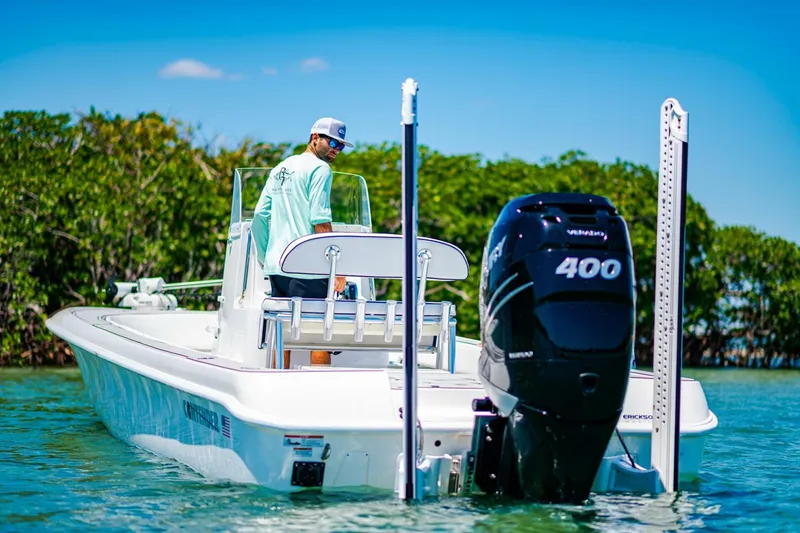 Slide: The Image of 2023 Contender 25 Bay boat with powerful 400hp engine on calm water. - 31