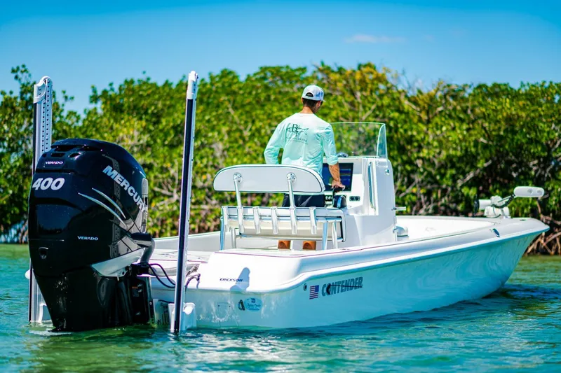 Slide: The Image of 2023 Contender 25 Bay boat with Mercury 400 engine in scenic water setting. - 33