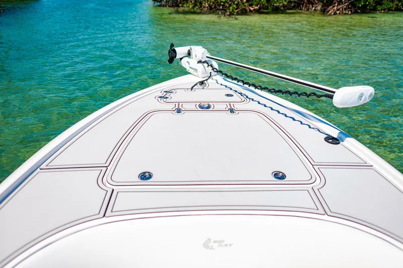 Slide: The Image of 2023 Contender 25 Bay boat on clear turquoise water. - 8