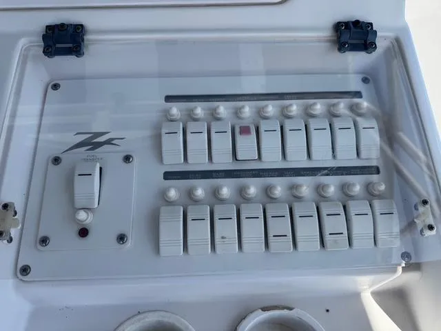 Slide: The Image of Control panel of a 2008 Donzi 35ZX boat with multiple switches and dials. - 12