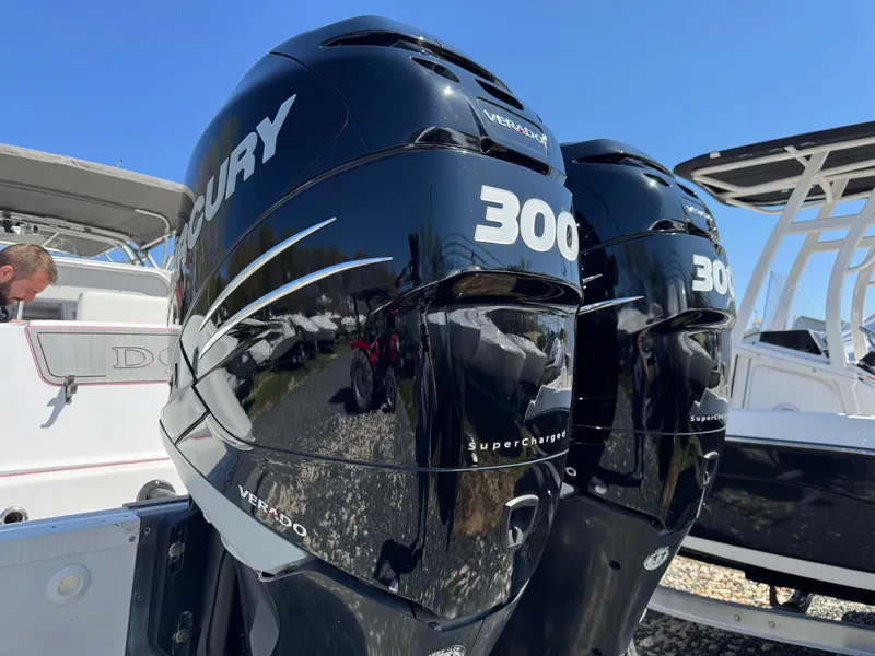 Slide: The Image of Twin Mercury 300 outboard engines on a 2008 Donzi 35ZX boat, under clear blue sky. - 15