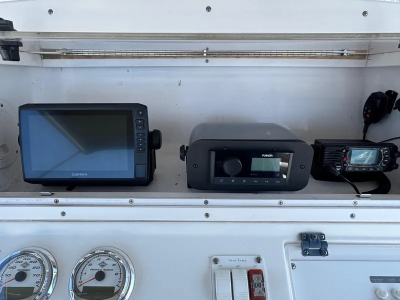 Slide: The Image of Control panel of a 2008 Donzi 35ZX boat with navigation and communication equipment. - 16