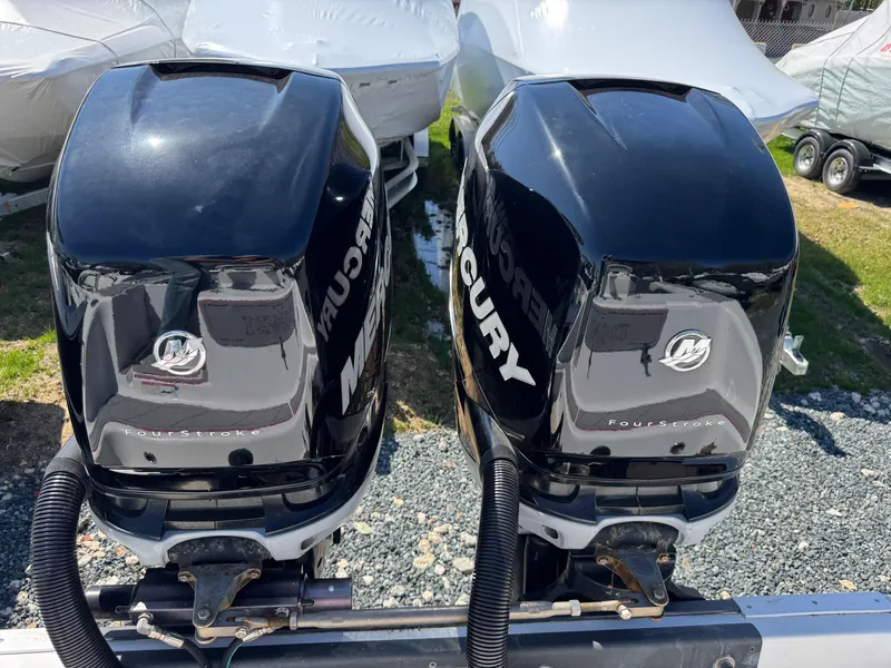Slide: The Image of Twin Mercury outboard engines on a 2008 Donzi 35ZX boat, parked outdoors. - 18