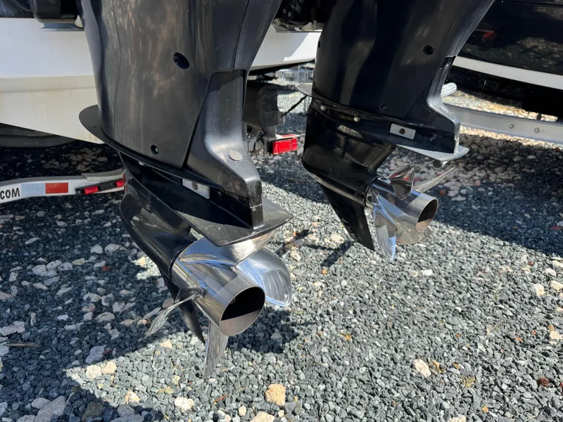 Slide: The Image of Twin propellers of a 2008 Donzi 35ZX boat on gravel surface. - 23