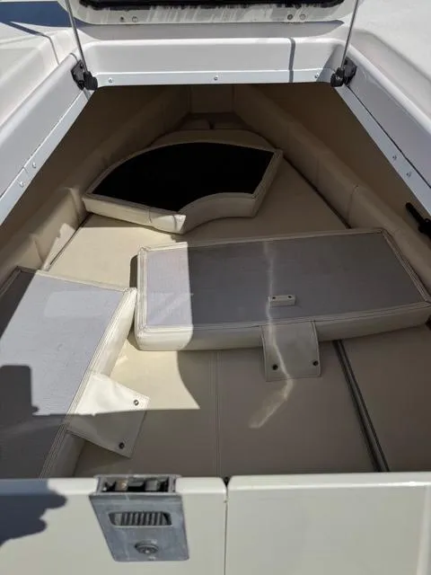 Slide: The Image of 2008 Donzi 35ZX boat interior with cushioned seating and storage compartments. - 28