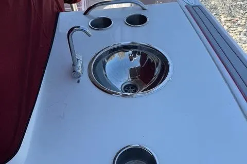 Slide: The Image of 2008 Donzi 35ZX boat sink with faucet and cup holders on deck. - 31