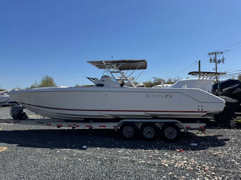 Slide: The Image of 2008 Donzi 35ZX boat on trailer, side view, under clear blue sky. - 4