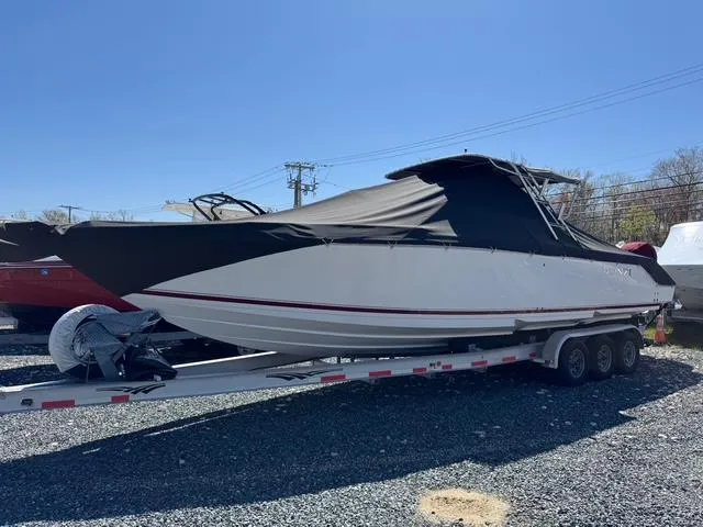 Slide: The Image of 2008 Donzi 35ZX boat on trailer, covered, parked on gravel lot. - 6