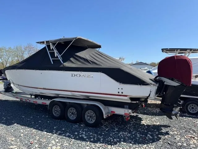 Slide: The Image of 2008 Donzi 35ZX boat on trailer, covered, parked outdoors. - 7